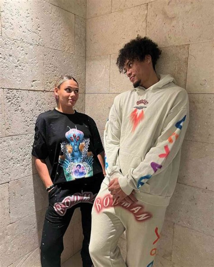 Both DJ Rodman and Trinity Rodman are smiling for the picture showing peace sign.