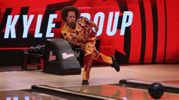 Kyle Troup hugging his bowling ball with great love.