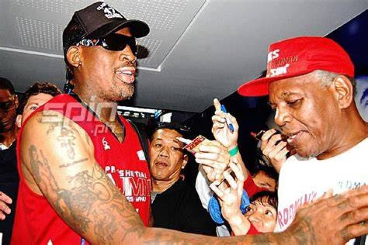 Philander Rodman is wearing a white tee and a red cap in the picture.